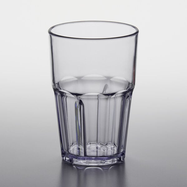 A close up of a clear plastic tumbler with a black rim.