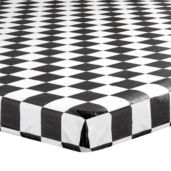 A white rectangular tablecloth with a black and white checkered design and elastic edges.