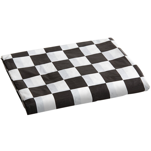 A white rectangular tablecloth with a black and white checkered pattern and elastic edges.