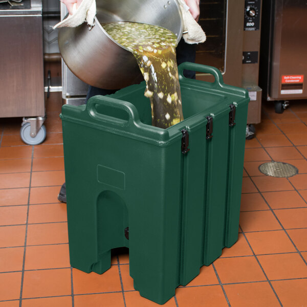A person pouring liquid into a green container.