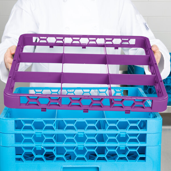 A man holding a purple Carlisle plastic rack extender over a purple plastic tray.