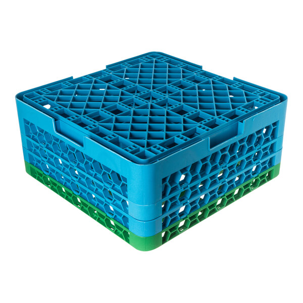 A blue and green plastic glass rack with 25 compartments and three extenders.