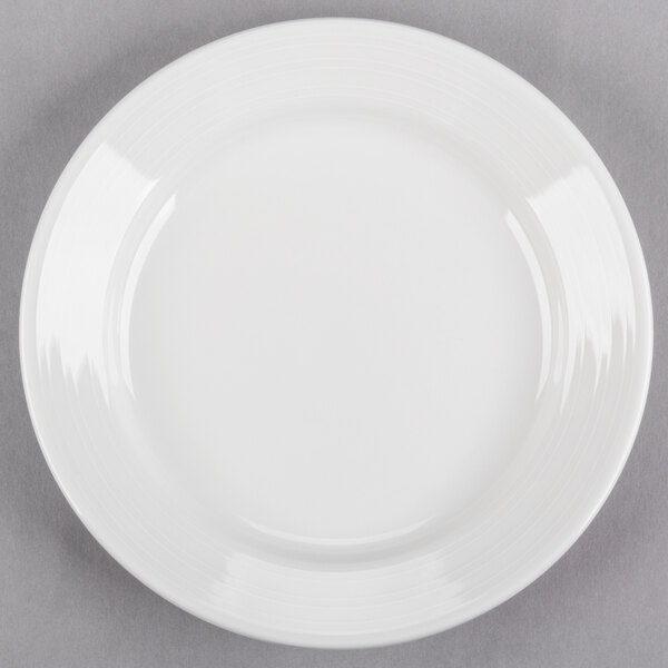 A Tuxton Pacifica bright white china plate with an embossed white rim.