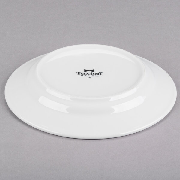 A Tuxton Pacifica bright white china plate with an embossed rim.