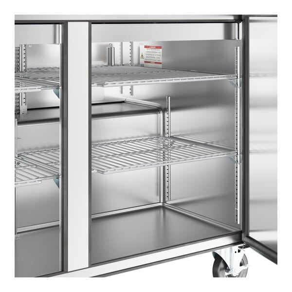 A True stainless steel refrigerator with shelves and doors.