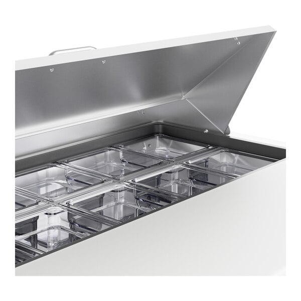 A True 48" 2 door refrigerated sandwich prep table on a counter in a professional kitchen.