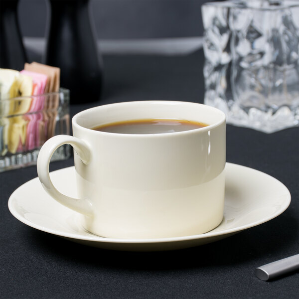 A white 10 Strawberry Street Royal Cream cup of coffee on a saucer.