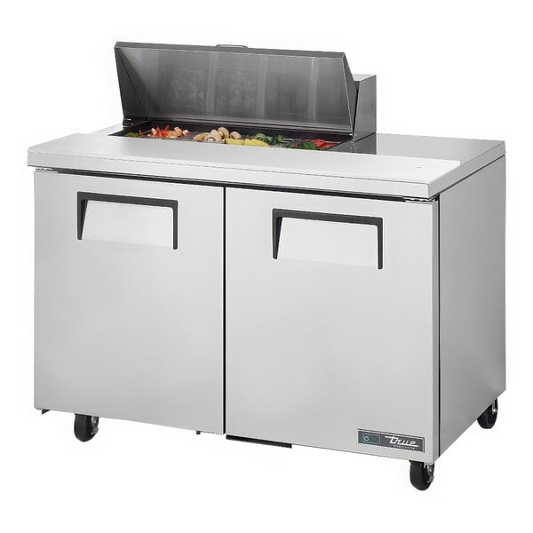 A True TSSU-48-08-HC Refrigerated Sandwich Prep Table with food on top.