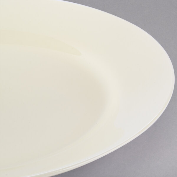 A close-up of a 10 Strawberry Street Royal Cream porcelain luncheon plate with a rim.