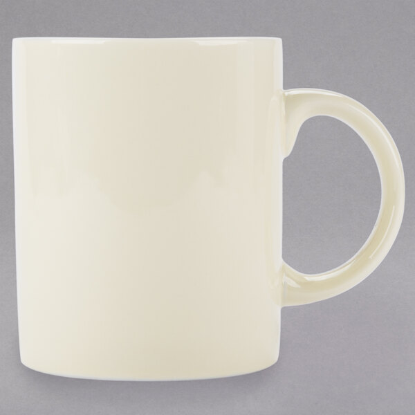 A white porcelain mug with a C-handle.