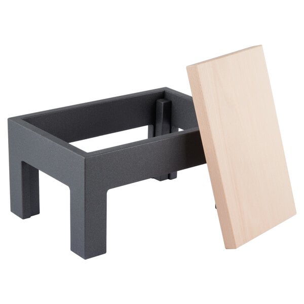 A black rectangular table with wood top legs and a wood board display.