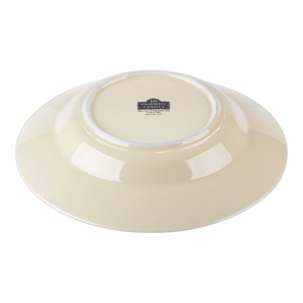 A cream-colored porcelain rim soup bowl shown upside down.