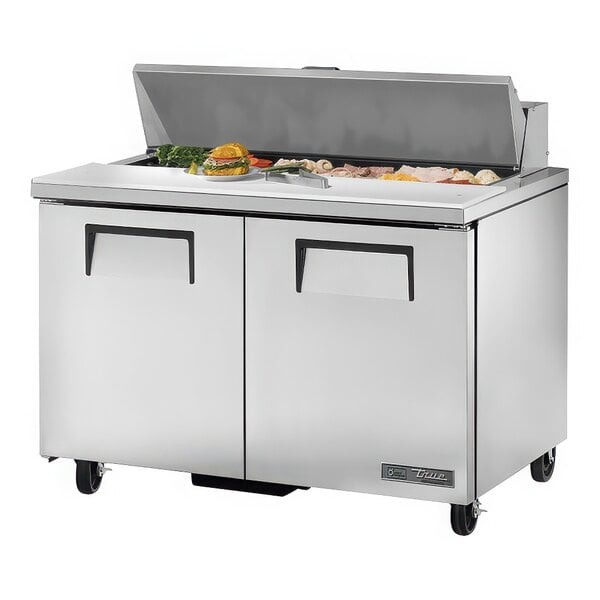 A True refrigerated sandwich prep table with food on top of it.