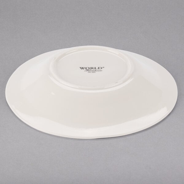 A Libbey round ivory porcelain pasta bowl with a white rim.