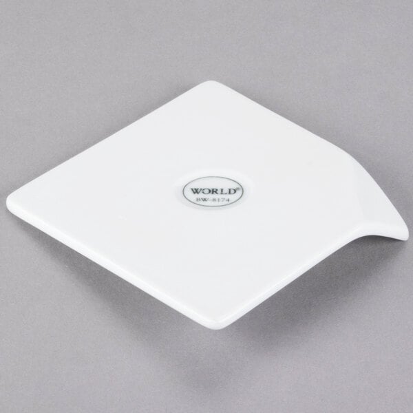A white square Libbey porcelain plate with a logo on the handle.