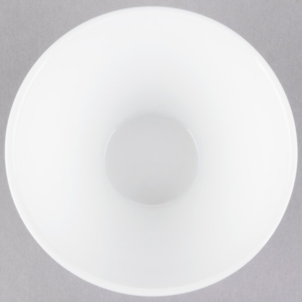 A white bowl with a hole in it.