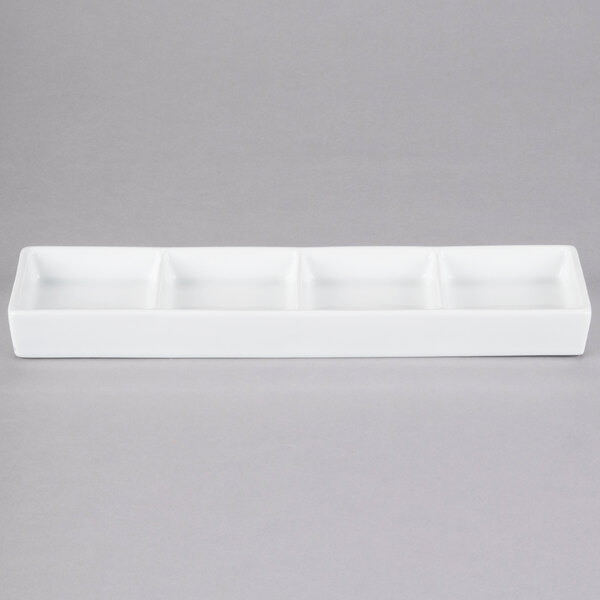 A white rectangular porcelain tray with four compartments.