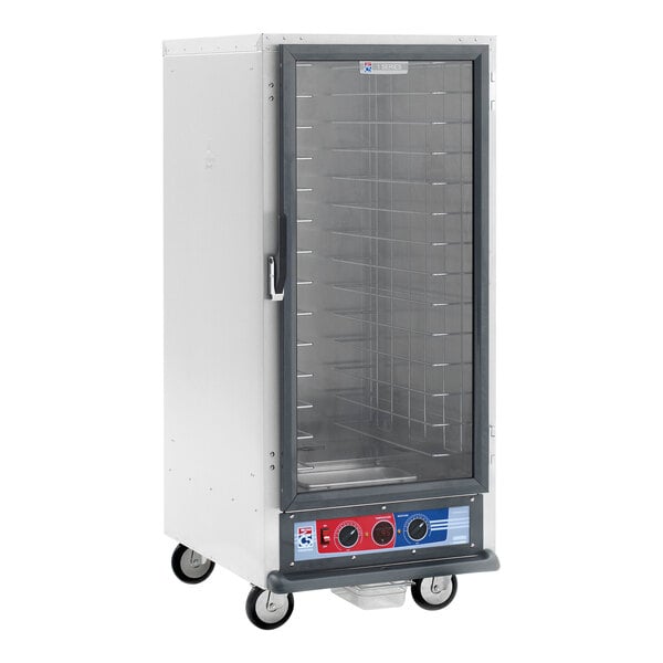 A large metal Metro C5 proofing cabinet with a clear glass door.