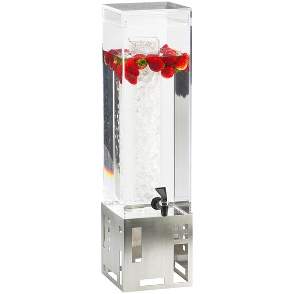 A Cal-Mil stainless steel beverage dispenser with ice chamber filled with water and strawberries.