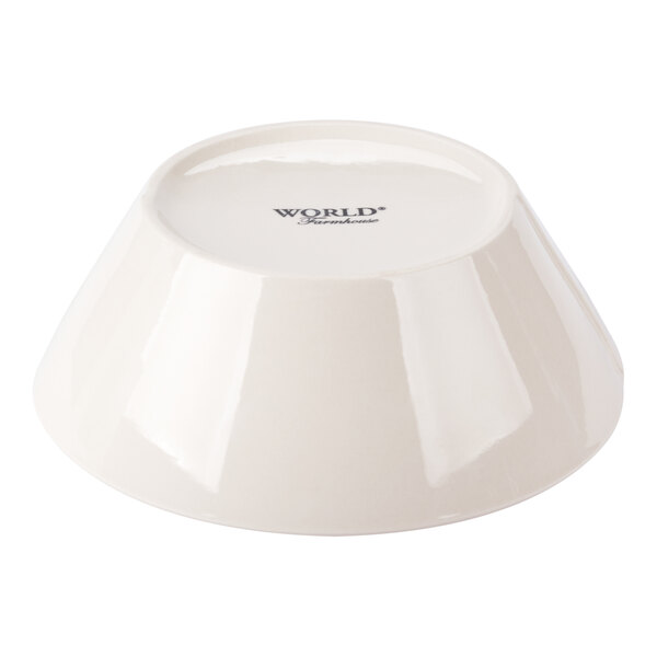 A round cream porcelain serving bowl shown upside down.