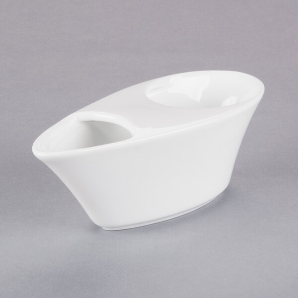 A white porcelain bar snack dispenser with a handle on a gray background.