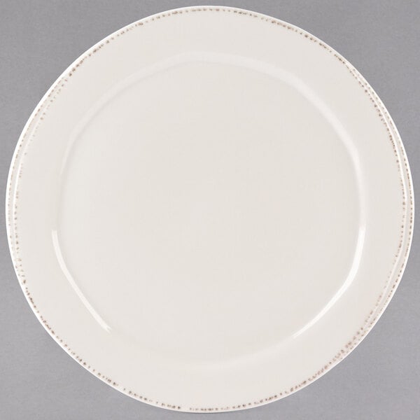 A Libbey round ivory porcelain plate with a medium rim.