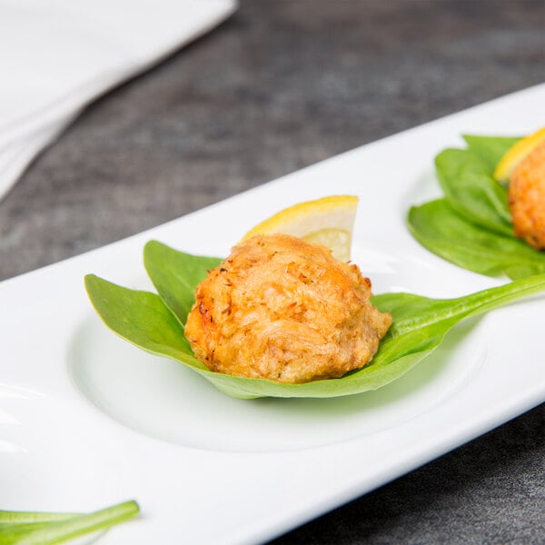 A Libbey porcelain tray with three small appetizers on it.