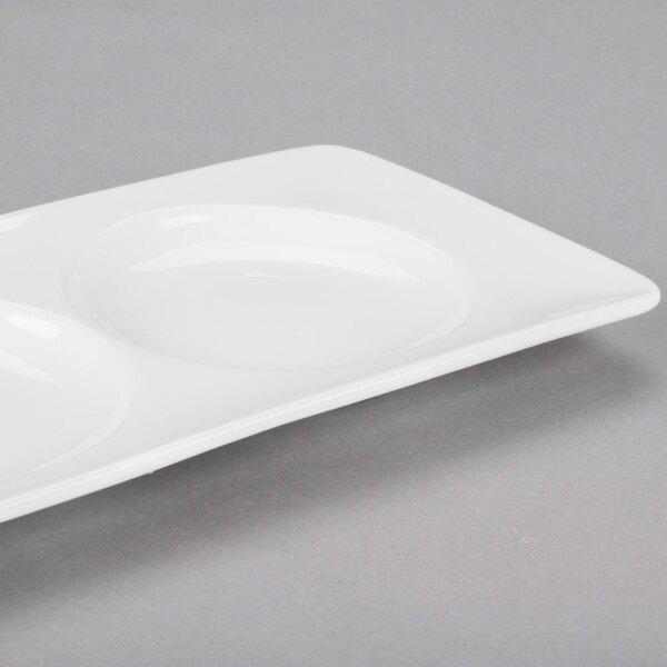A white porcelain tray with three wells.
