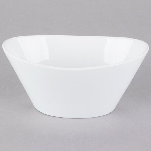 A Libbey Neptune bowl in white porcelain on a gray background.