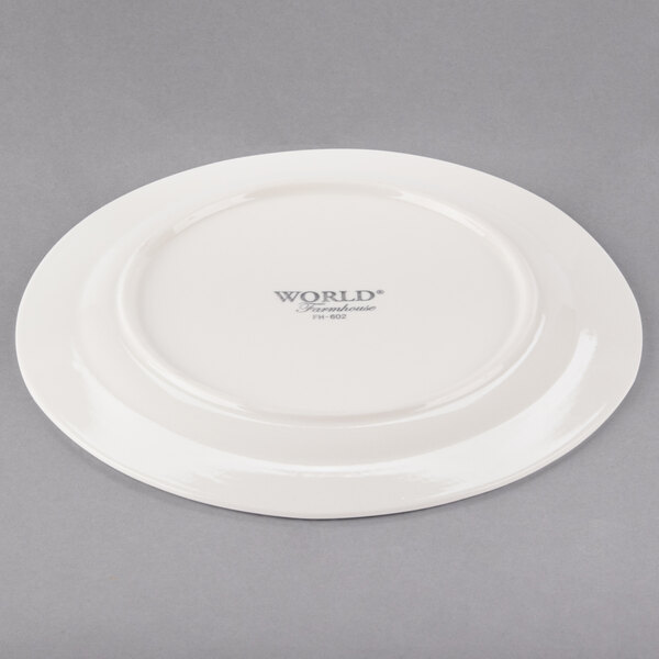 A Libbey medium rim porcelain plate in ivory with a logo on it.