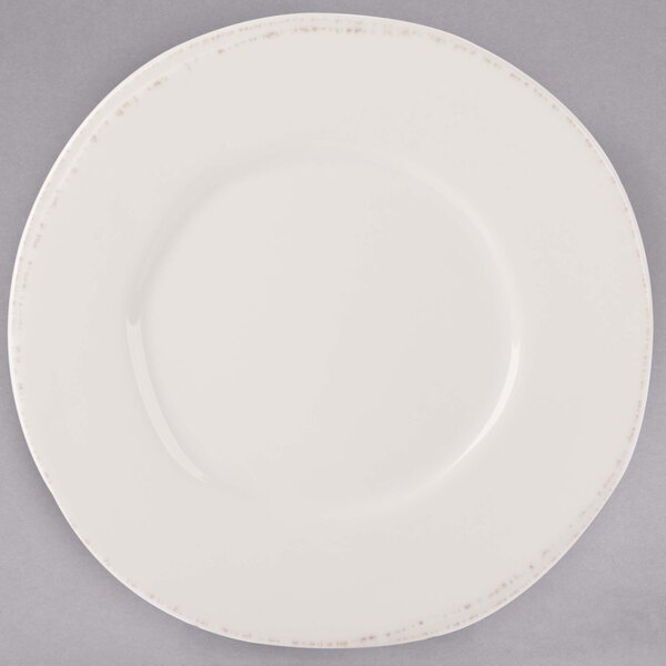A Libbey Farmhouse ivory porcelain plate with a wide rim.