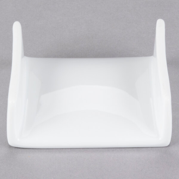 A close up of a white circular porcelain plate with an elevated rim.