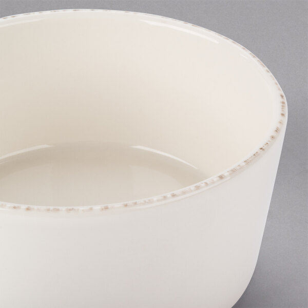A close up of a Libbey Farmhouse ivory porcelain bowl with a small rim.
