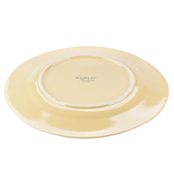 A Libbey butter yellow porcelain plate with a wide white rim.