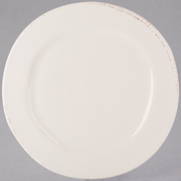 A Libbey ivory porcelain plate with a brown rim.