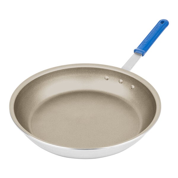 A Vollrath Wear-Ever aluminum fry pan with a blue Cool Handle.
