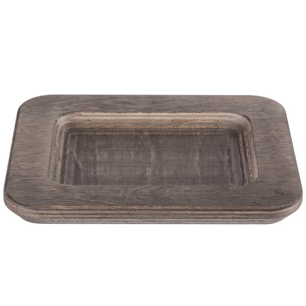 A Lodge rectangular wooden underliner with a walnut finish.