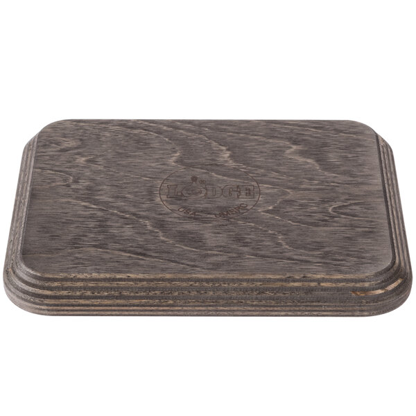 A Lodge rectangular wood underliner with a walnut finish and a logo on it.