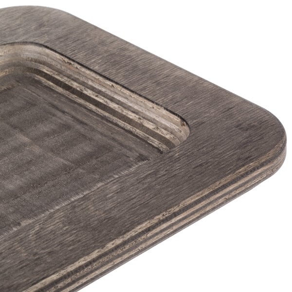 A Lodge rectangular wood underliner with a walnut finish.