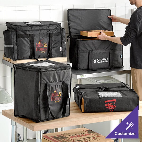 A man holding a black Choice insulated pizza delivery bag with a handle.