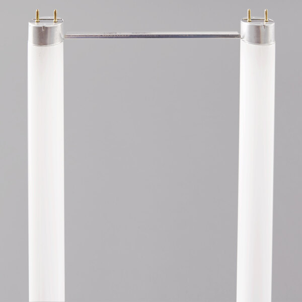 A white rectangular object with two white tubes and metal rods.