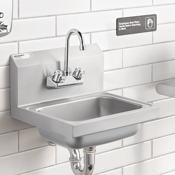 A Regency wall mounted hand sink with a gooseneck faucet over it.