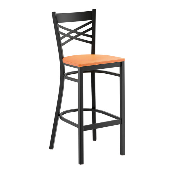 A black metal bar stool with a cross back design and a cherry wood seat.