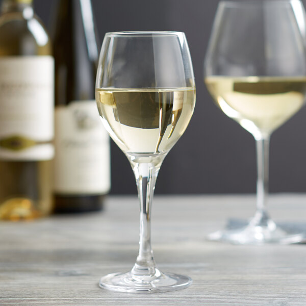 A close-up of a Stolzle Nadine dessert wine glass filled with white wine.