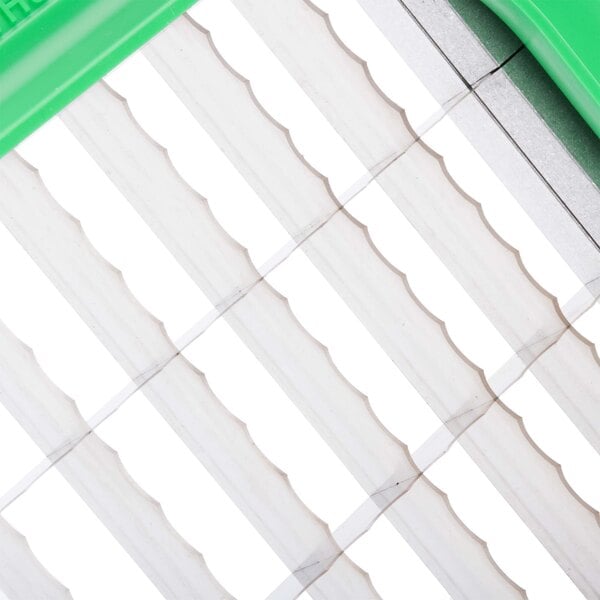 A green and white plastic Prince Castle Saber King lettuce chopper blade assembly.