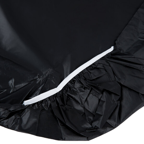 A black plastic tablecloth with white elastic edges.