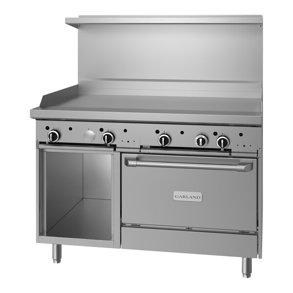 A stainless steel Garland commercial range with griddle, oven, and storage.