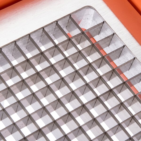 A metal grid with many square holes.