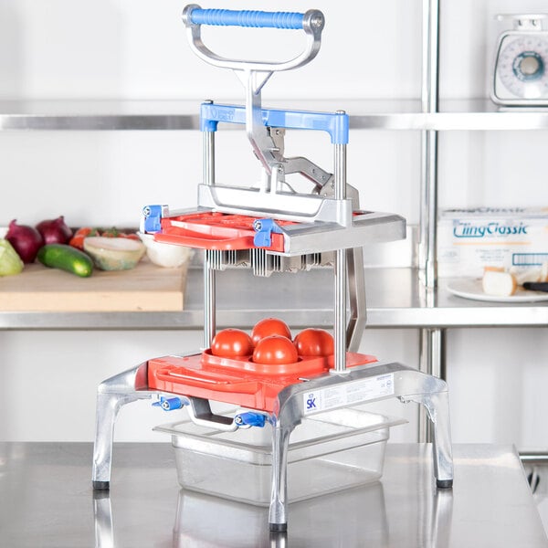 A Prince Castle Saber King Tomato Slicer with tomatoes on it.