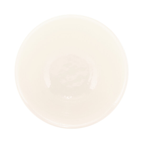 An Elite Global Solutions Durango round melamine bowl in antique white with a chocolate rim.